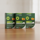 Three boxes of eyetamins by Optifade on a wooden surface with a neutral background