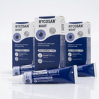 Hycosan Night eye drops packaging, including three blue and white boxes and one blue tube, arranged on a clean white reflective surface.