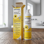 OPTASE Manuka Oil Cleansing Gel shown with its retail box and a single pump bottle on a wooden tabletop in a softly blurred indoor setting.