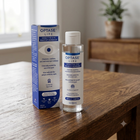 OPTASE LIFE Sensitive Eye Makeup Remover bottle and its blue-and-white retail box, placed on a wooden table in a softly blurred indoor setting.
