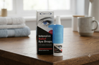 Eyelects Intensive Relief Eye Drops shown with its retail box and dropper bottle on a wooden table in a softly blurred home setting.