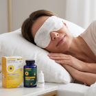 A woman lying in bed with an eye mask over her eyes, with Optase eye drops packaging and bottle displayed on a bedside table.