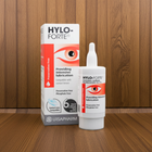 A bottle of HYLO-FORTE preservative-free contact lens lubricant stands in front of its retail box on a wooden surface against a wooden wall background. The packaging features white, red, and orange colors with an eye graphic.