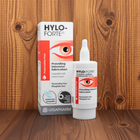 Ursapharm Hylo-Forte preservative-free contact lens solution bottle and packaging box displayed on a wooden surface against a wooden background.