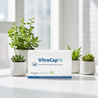 VitroCap N dietary supplement box displayed on a white surface with small potted green plants in the background.