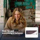 Smiling woman using her phone, with Dailies Total 1 Multifocal pack inset