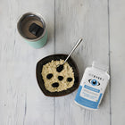 Viteyes2 Advanced supplement bottle next to a bowl of food and a mug on a wooden surface.ocular express